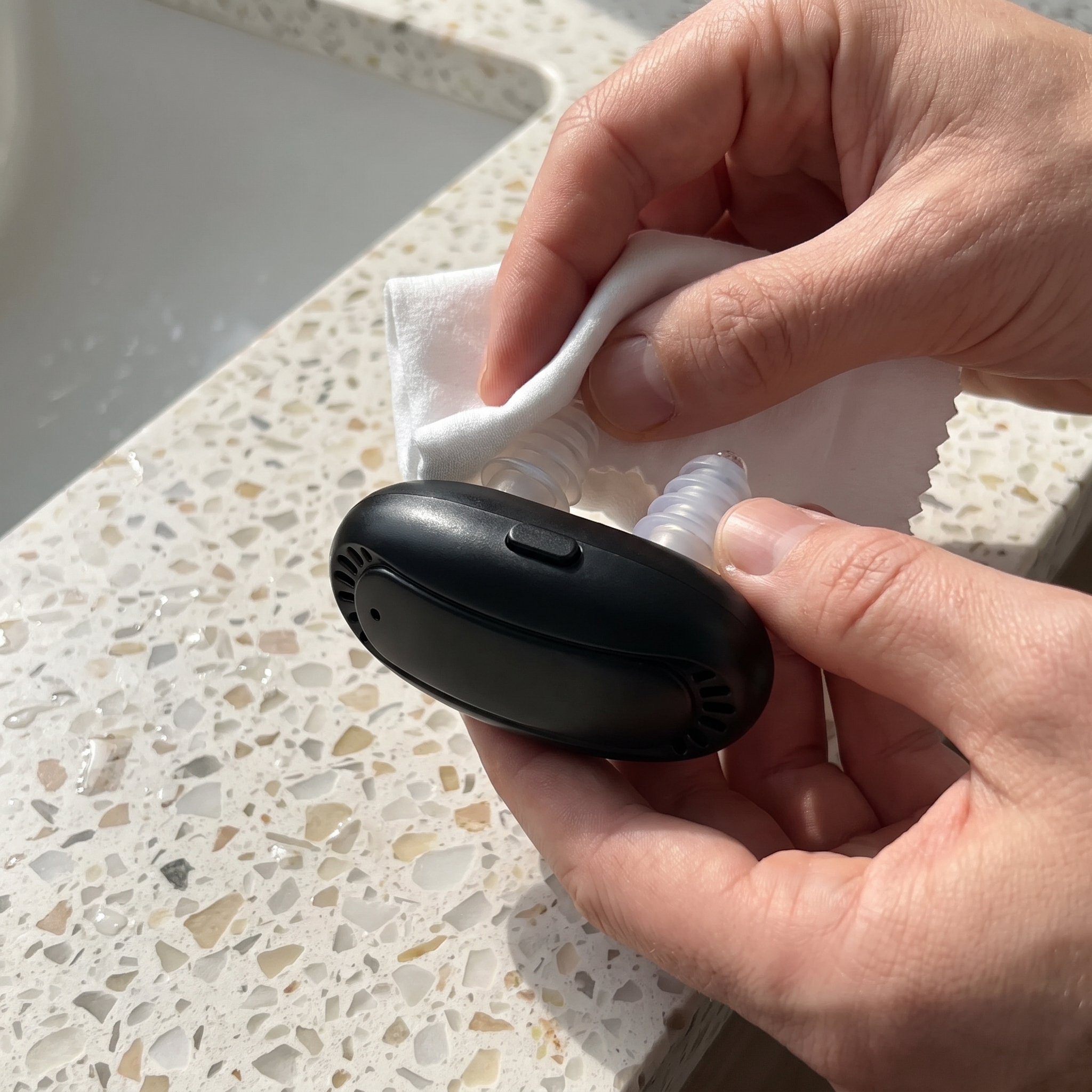 Wiping the reusable silicone prongs with a clean cloth